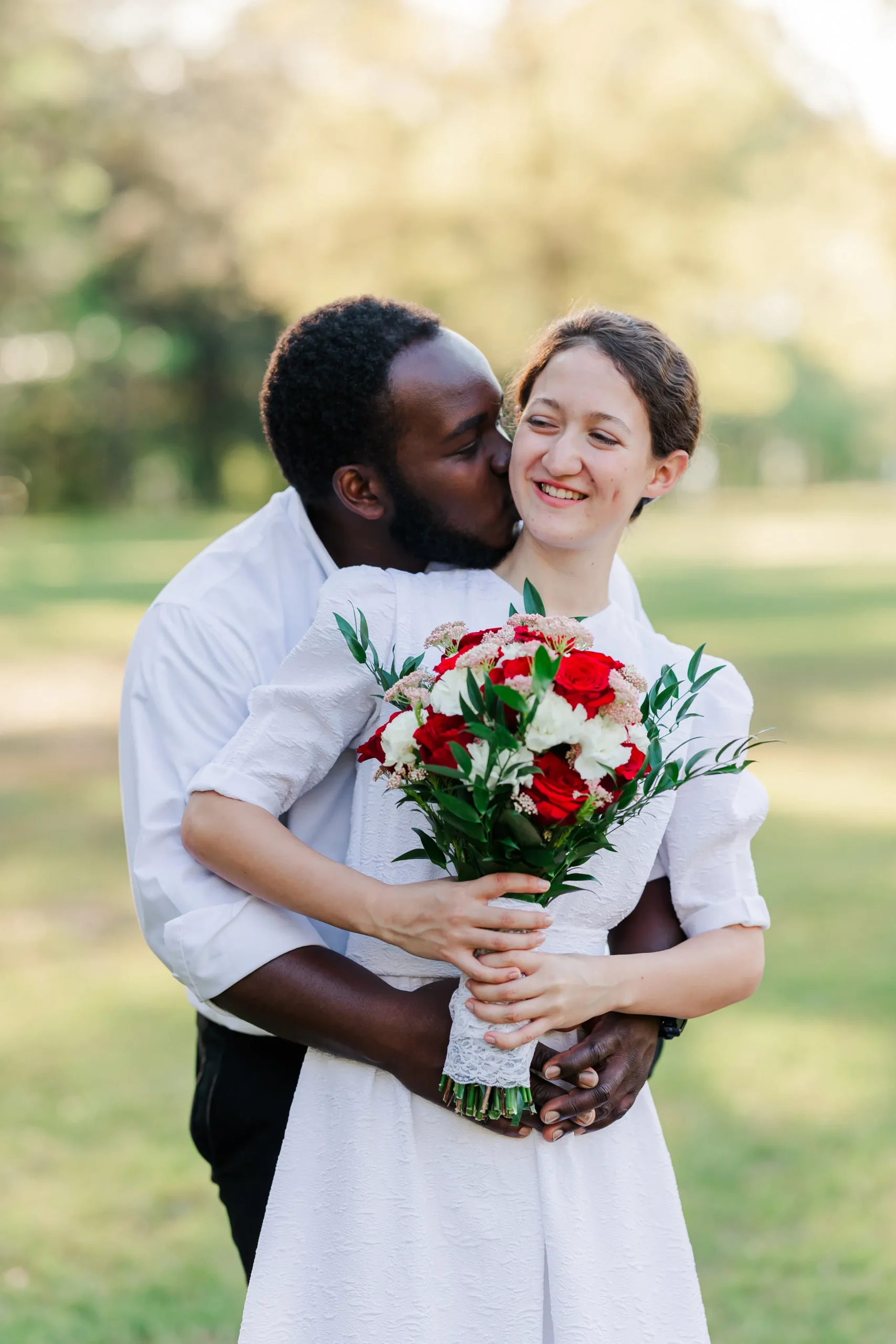 bride and groom with bride laughing off to the side